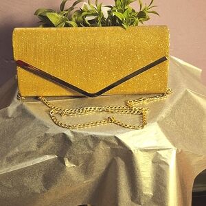Ladies clutch bag with gold strap.